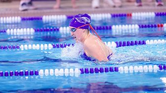 A UW-Whitewater swimmer competing in the pool at UW-La Crosse